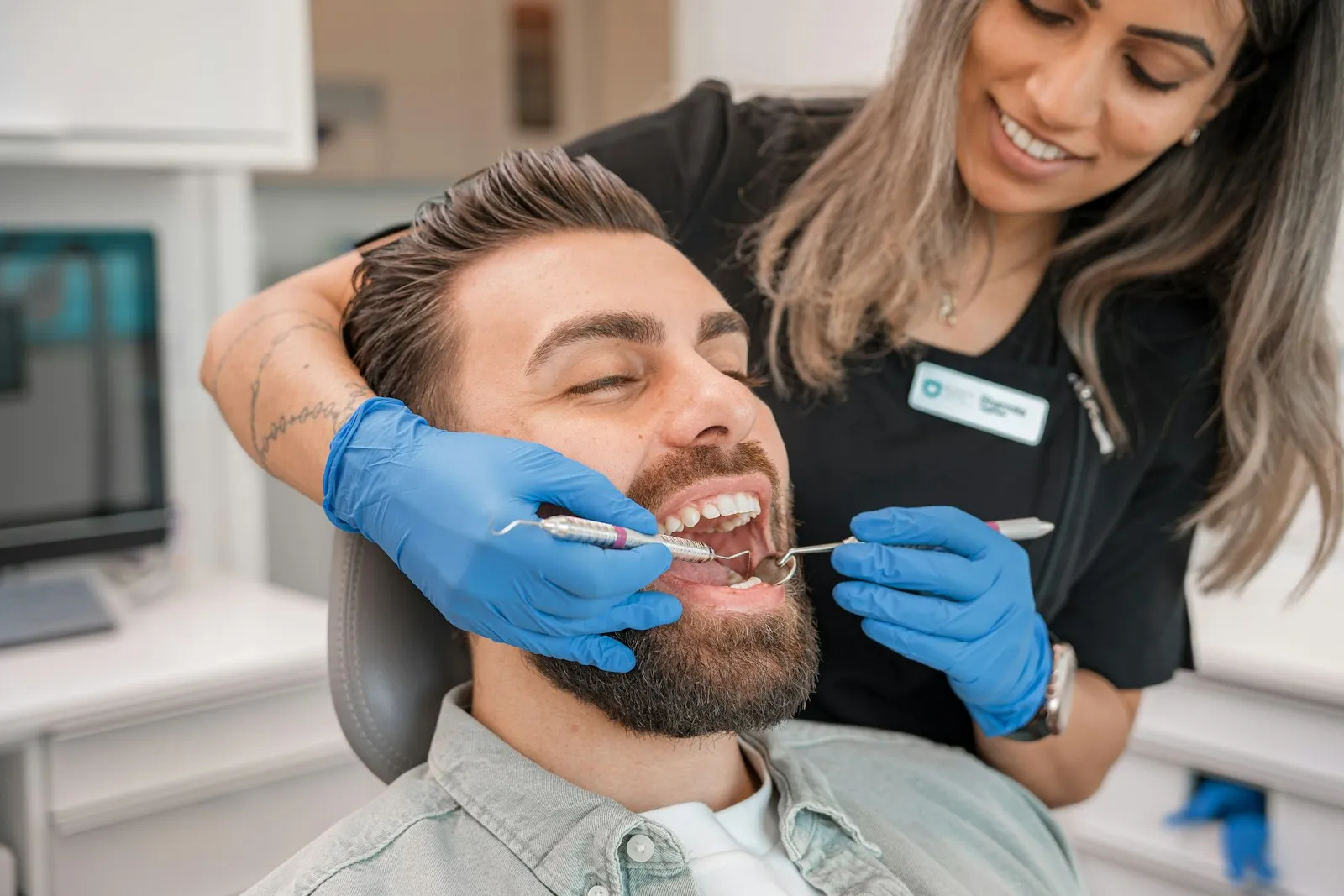 Patient laughing with a dentist in the treatment chair
